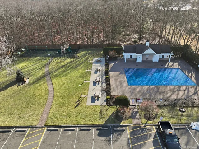 a view of swimming pool with a patio and a yard