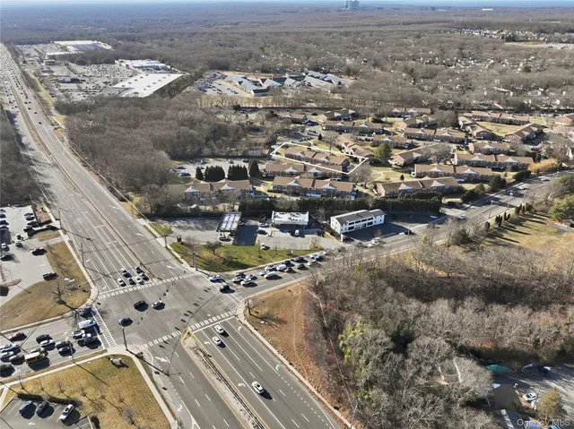 an aerial view of residential houses with yard