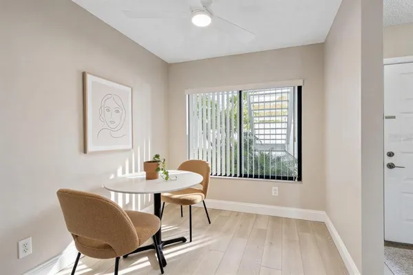 a dining room with furniture and wooden floor