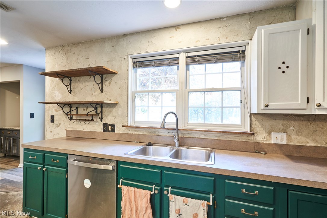 780 Bates Road Rocky River, OH 44116 - Photo 10 of 35 Kitchen featuring deep green base cabinetry, stainless steel dishwasher, and a double basin sink