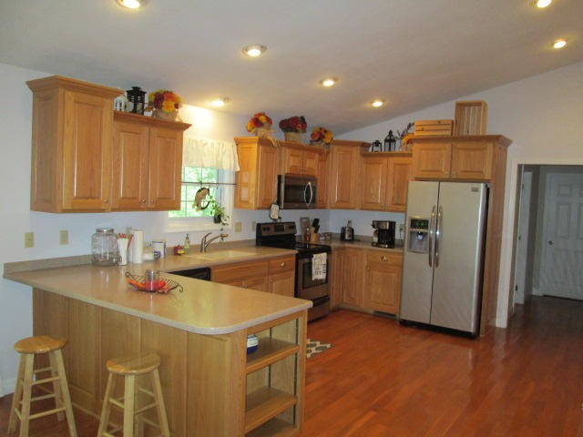 1557 Hillendale Road Crossville, TN 38572 - Photo 3 of 20 a kitchen with a refrigerator a sink dishwasher and a stove with wooden floor