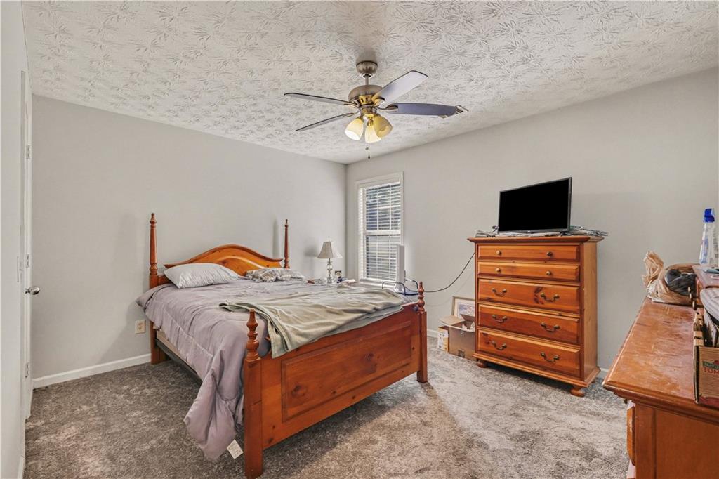 280 Courtyard Circle Winder, GA 30680 - Photo 12 of 24 a bedroom with a bed and a tv on the dresser