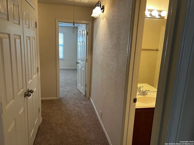 a view of a bathroom from a hallway