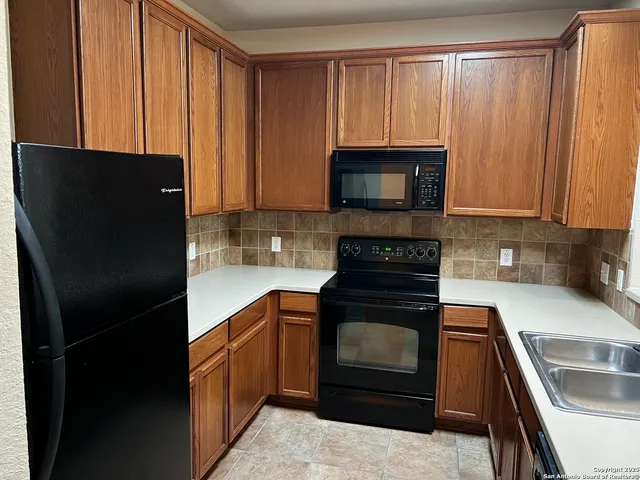 a kitchen with a refrigerator stove and microwave