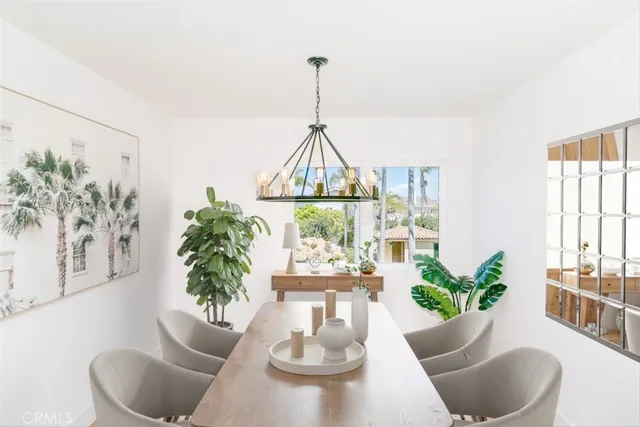 a kitchen with stainless steel appliances kitchen island granite countertop a table chairs in it and wooden floors