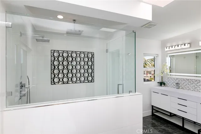 a bathroom with a sink vanity and a mirror
