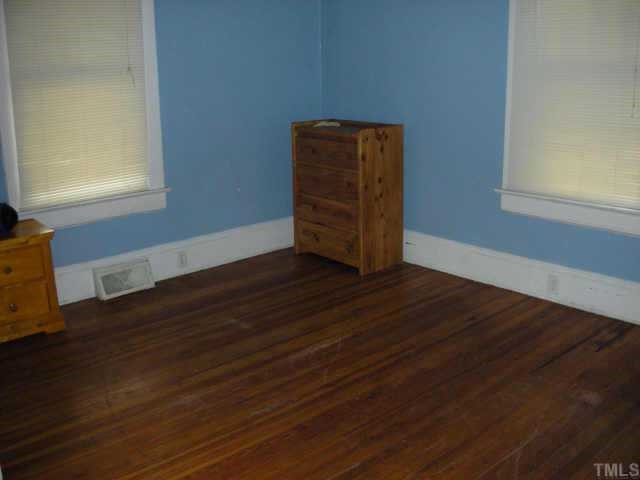 2319 Garner Road Raleigh, NC 27610 - Photo 4 of 6 a view of an empty room with wooden floor and a window