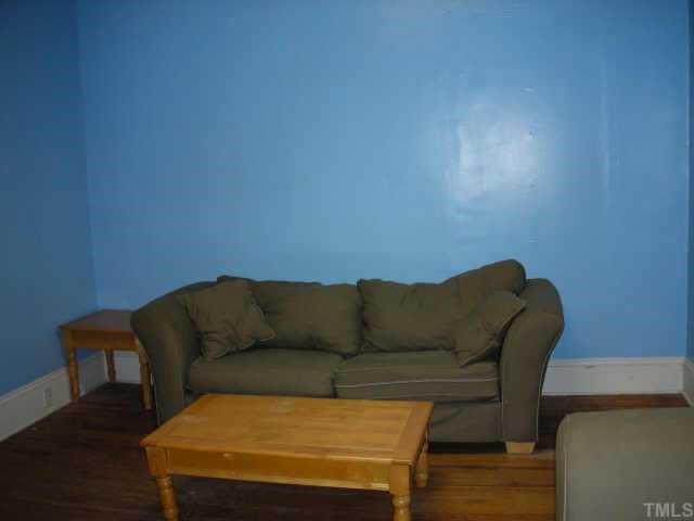 2319 Garner Road Raleigh, NC 27610 - Photo 6 of 6 a living room with furniture and a wooden floor