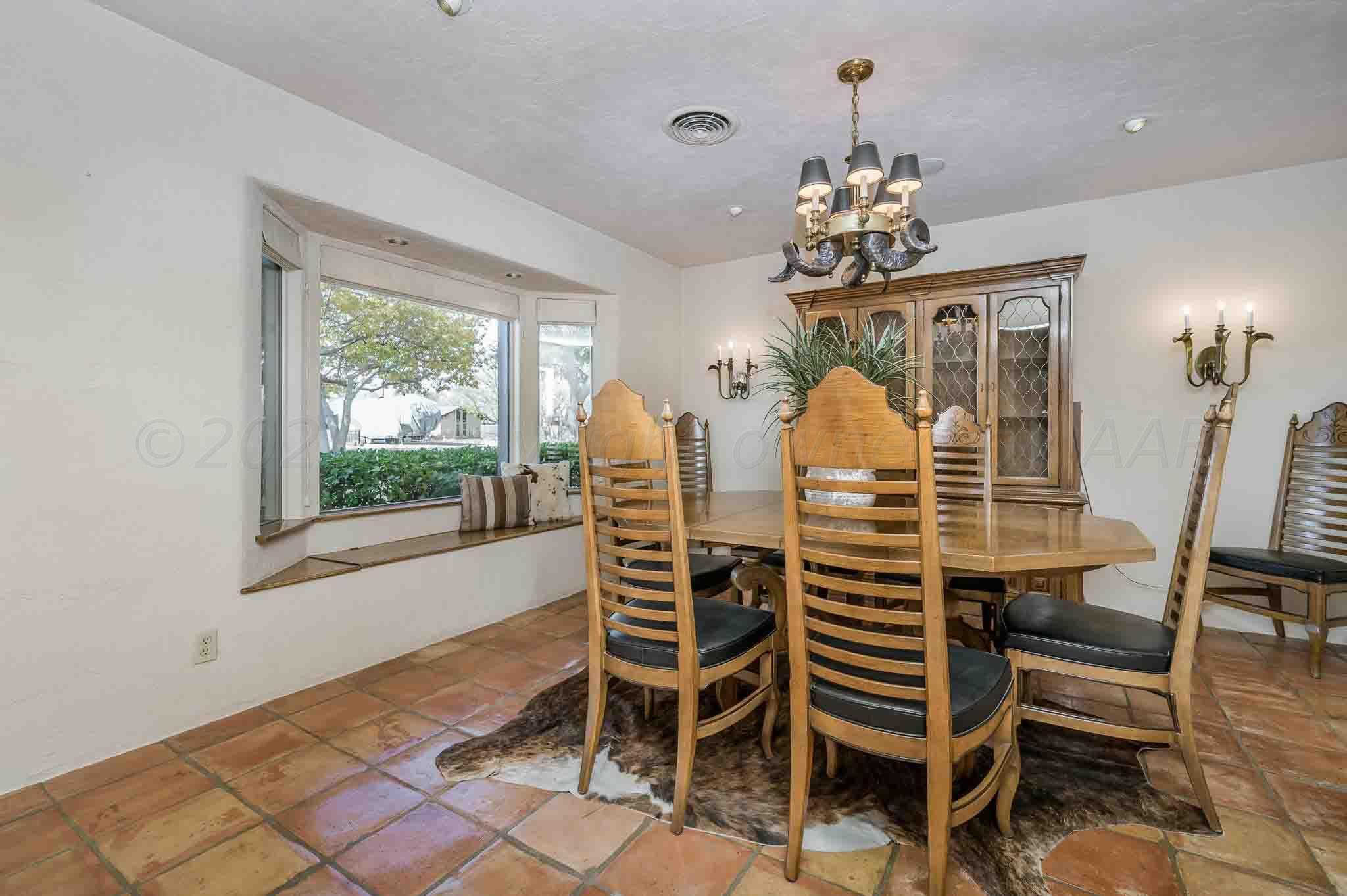 7517 Duling Lane Amarillo, TX 79110 - Photo 12 of 80 a dining room with furniture a chandelier and window