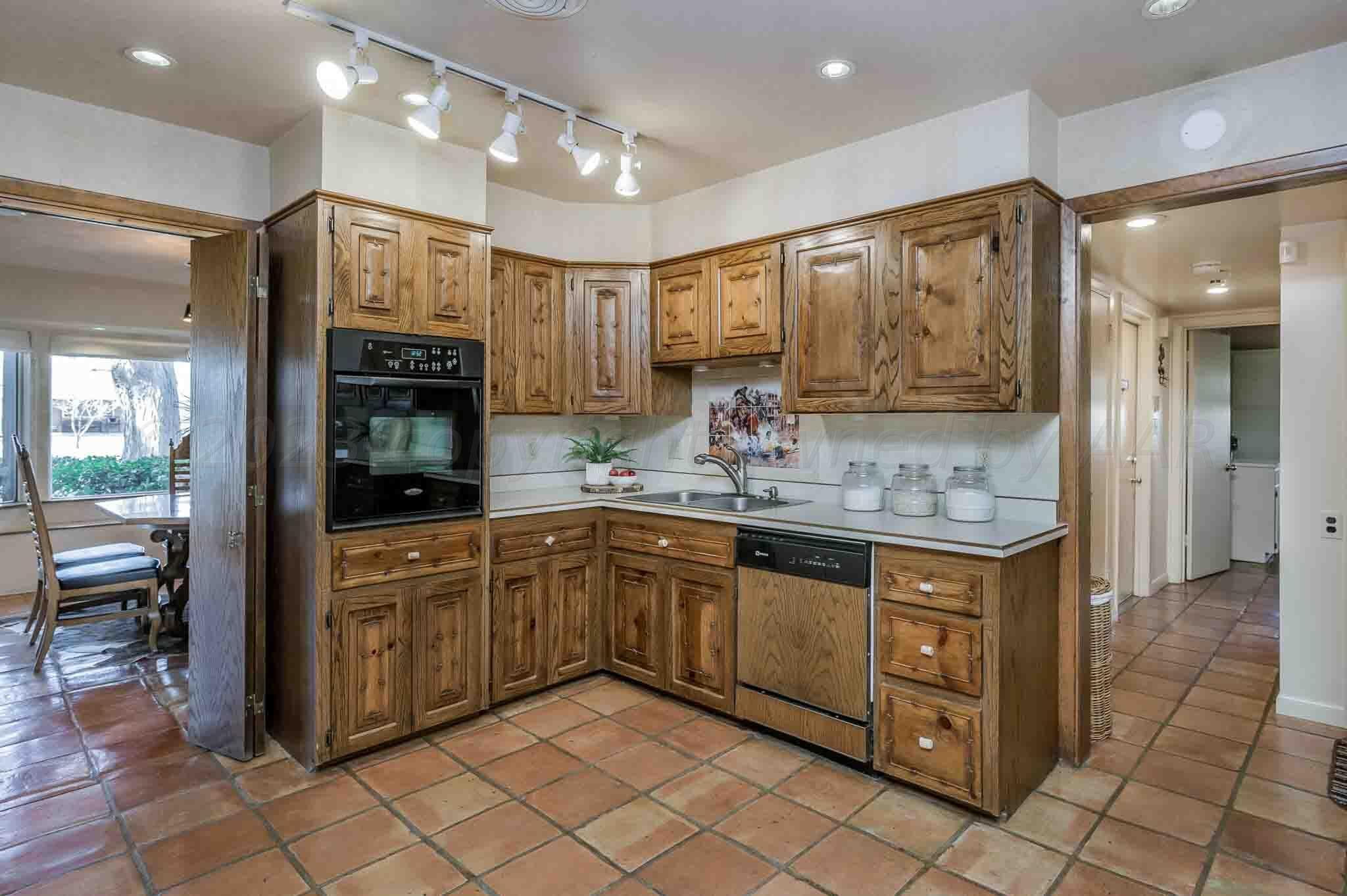 7517 Duling Lane Amarillo, TX 79110 - Photo 13 of 80 a kitchen with stainless steel appliances granite countertop a sink and cabinets