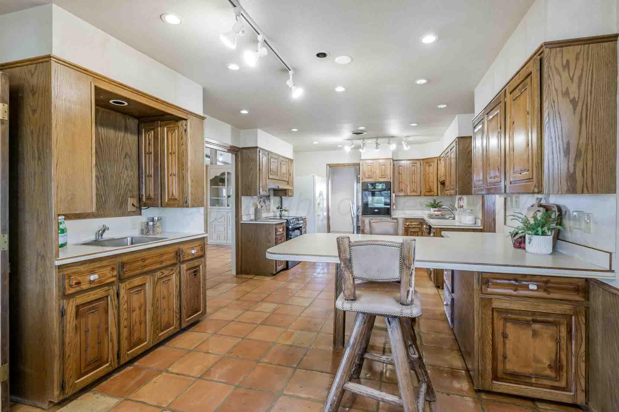 7517 Duling Lane Amarillo, TX 79110 - Photo 15 of 80 a kitchen with kitchen island granite countertop lots of counter top space and stainless steel appliances