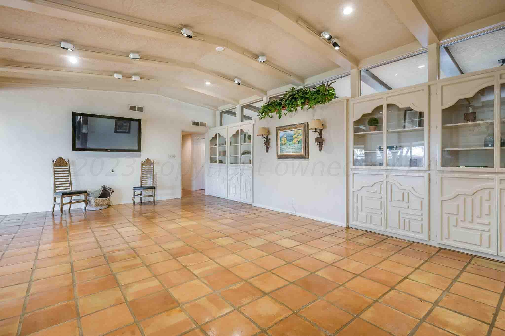 7517 Duling Lane Amarillo, TX 79110 - Photo 17 of 80 a view of a livingroom with furniture and a flat screen tv