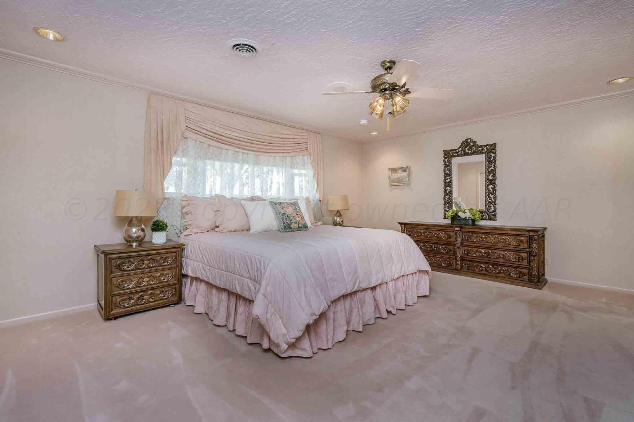 7517 Duling Lane Amarillo, TX 79110 - Photo 22 of 80 a spacious bedroom with a bed dresser and a window