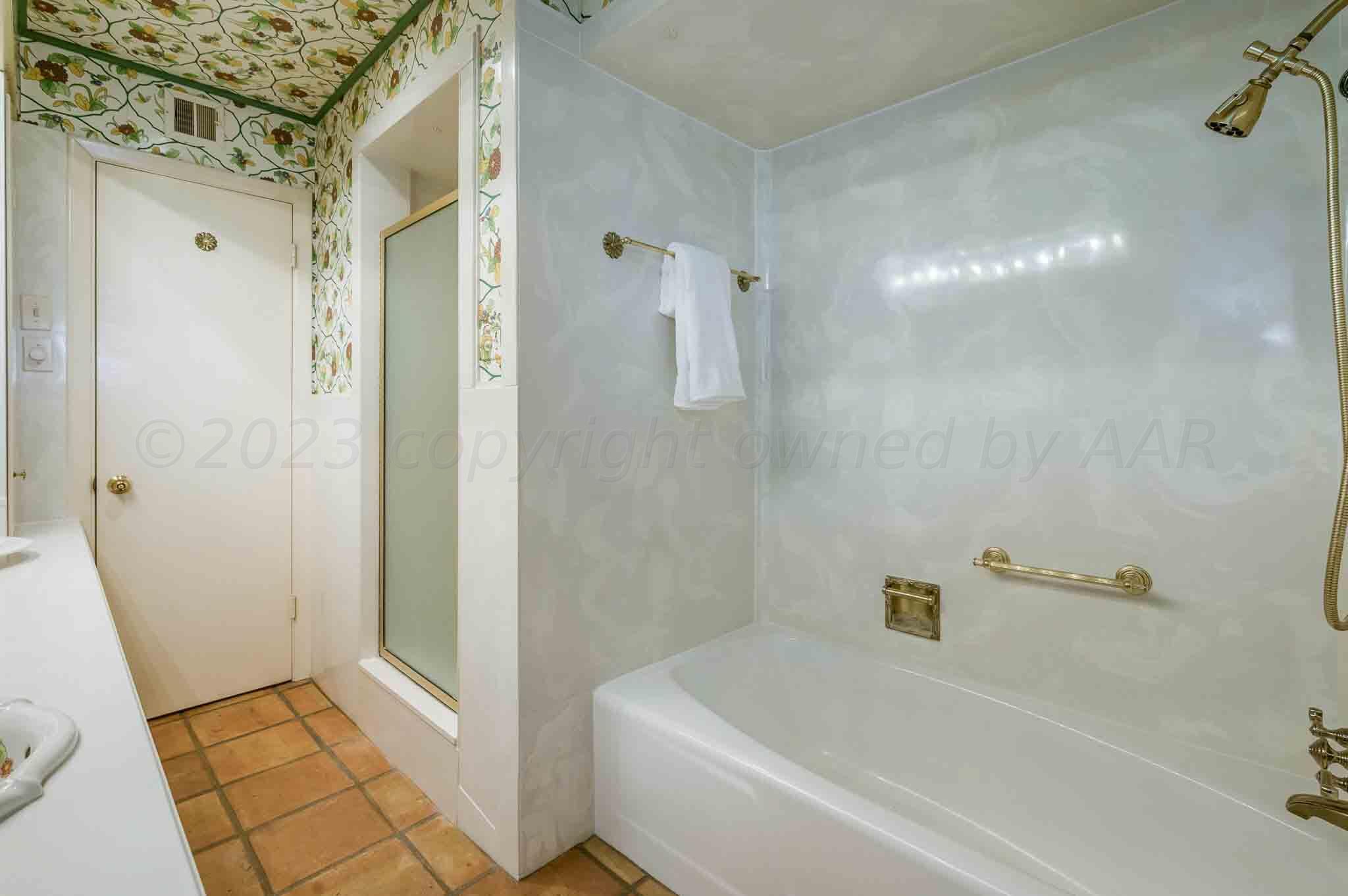 7517 Duling Lane Amarillo, TX 79110 - Photo 34 of 80 a bathroom with a bathtub and a shower