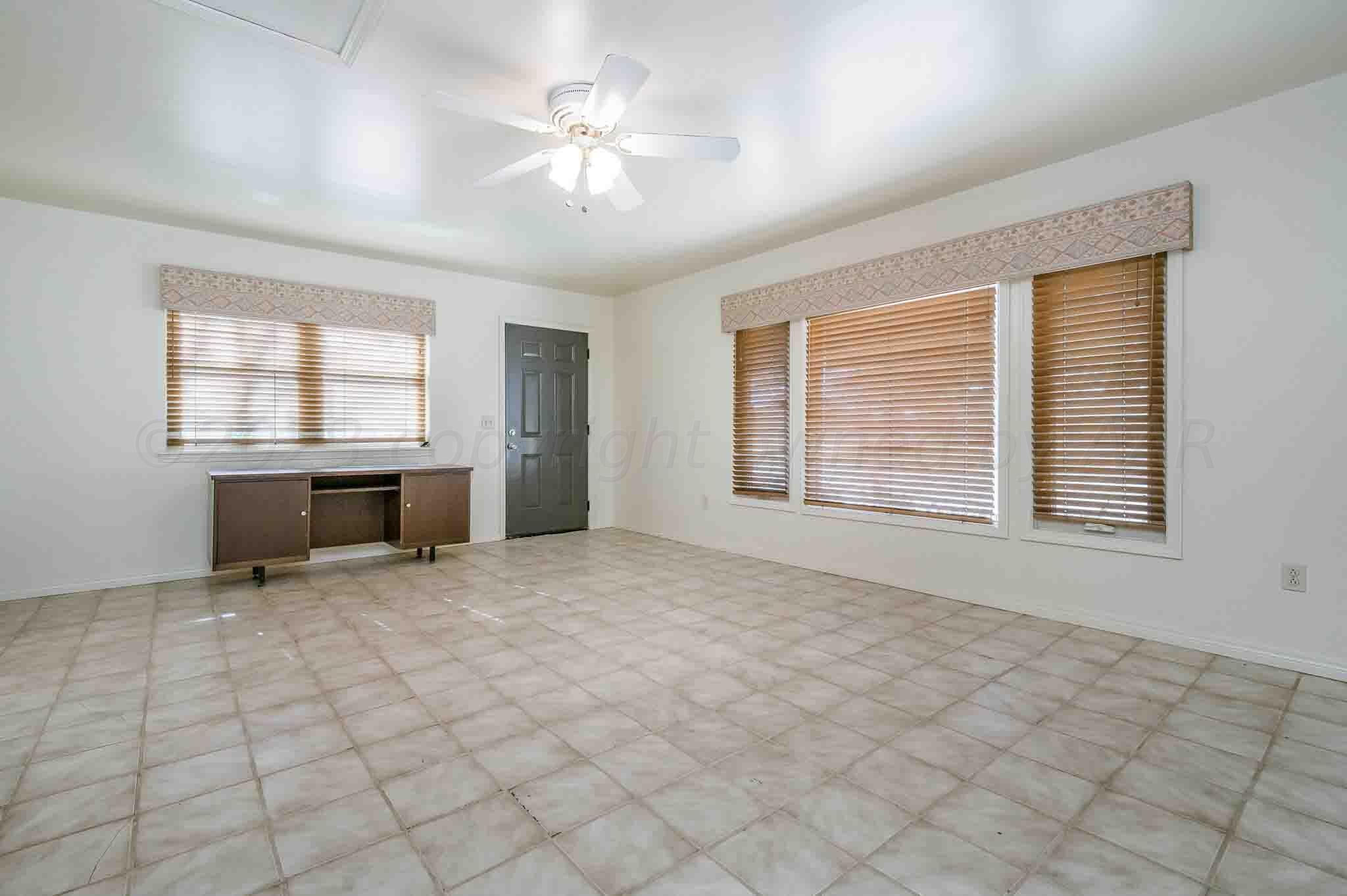 7517 Duling Lane Amarillo, TX 79110 - Photo 40 of 80 an empty room with windows and ceiling fan