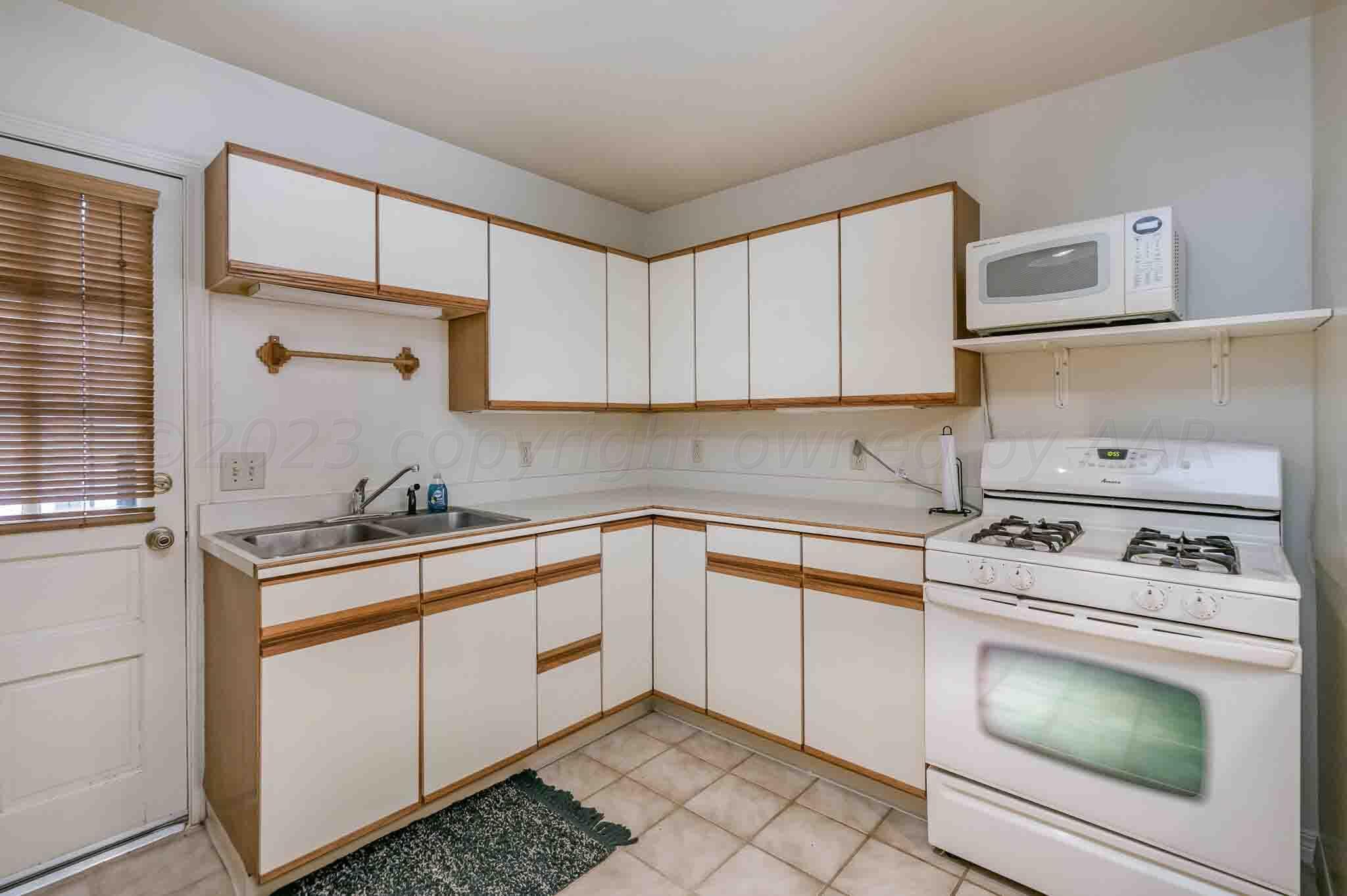 7517 Duling Lane Amarillo, TX 79110 - Photo 43 of 80 a kitchen with cabinets appliances and a sink