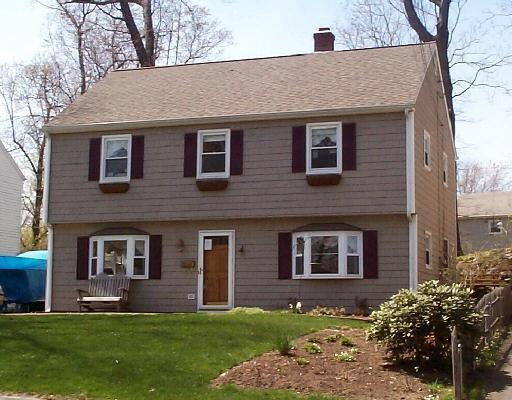 a brick house that is sitting in front of a house