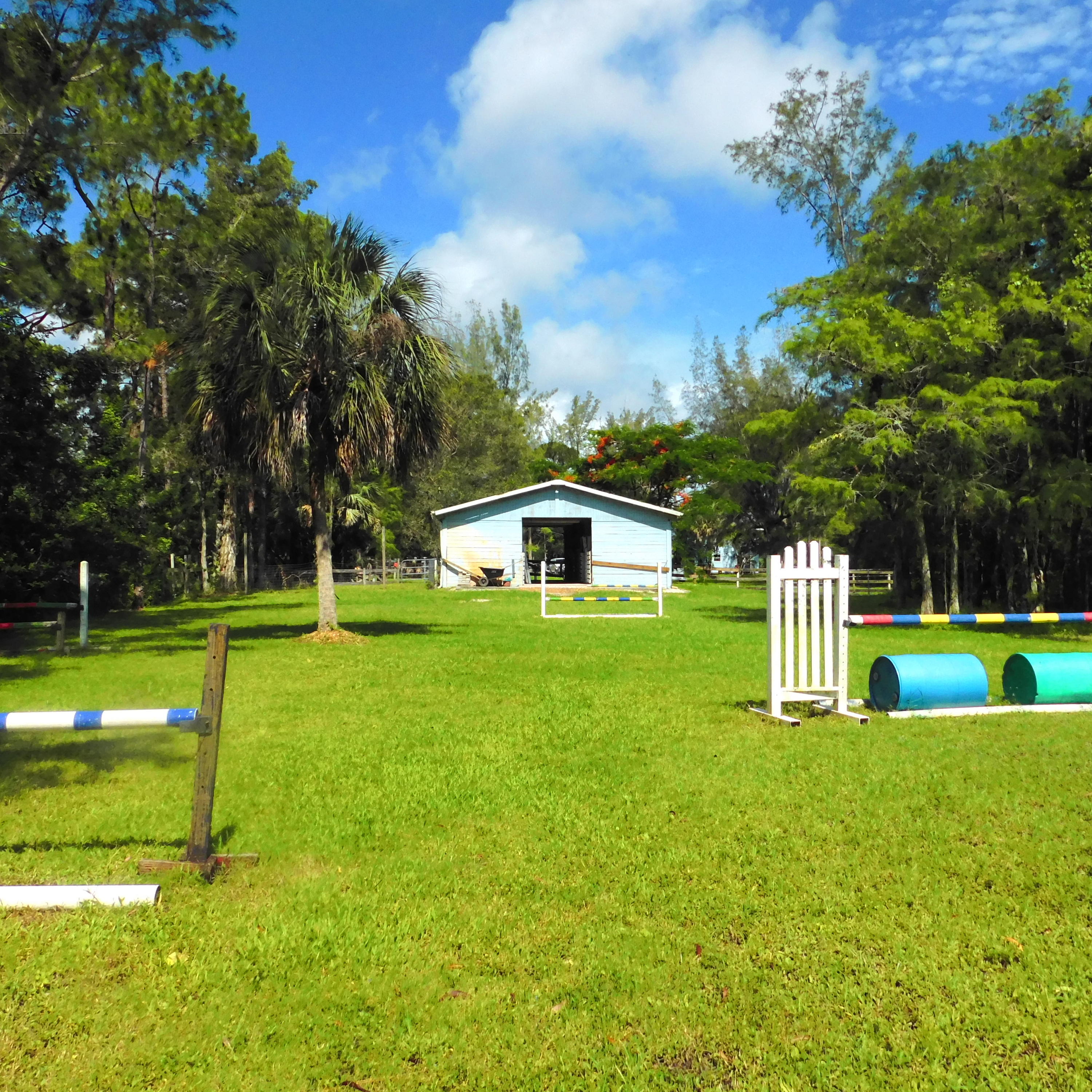 1032 Hyde Park Road Loxahatchee, FL 33470 - Photo 16 of 24 a front view of a house with garden