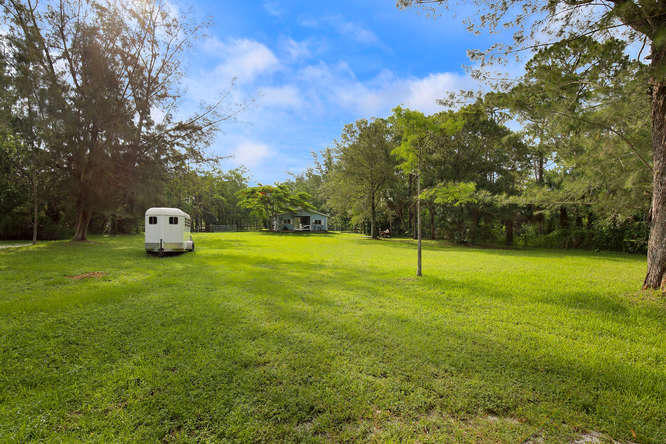 1032 Hyde Park Road Loxahatchee, FL 33470 - Photo 22 of 24 a backyard of a house with lots of green space