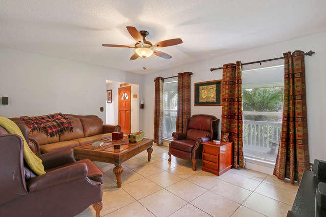 1032 Hyde Park Road Loxahatchee, FL 33470 - Photo 3 of 24 a living room with furniture and a flat screen tv