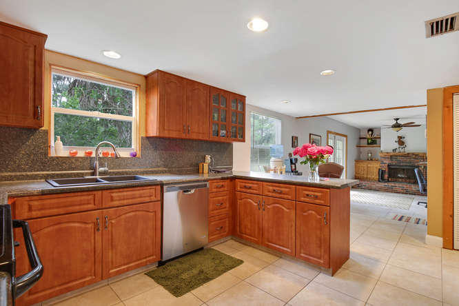 1032 Hyde Park Road Loxahatchee, FL 33470 - Photo 7 of 24 a kitchen with a sink and cabinets