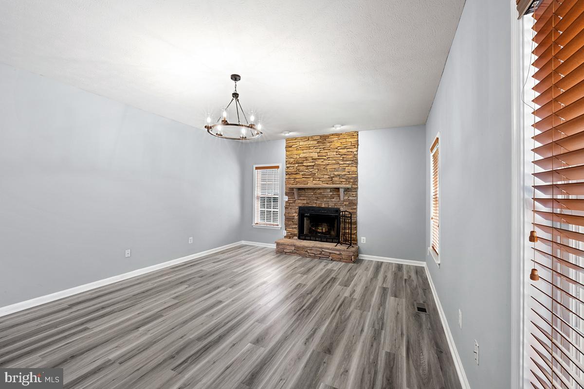 35184 Pheasant Ridge Road Locust Grove, VA 22508 - Photo 42 of 64 an empty room with wooden floor fireplace and windows