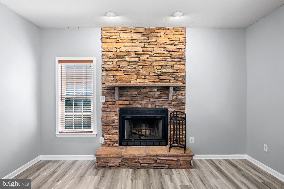35184 Pheasant Ridge Road Locust Grove, VA 22508 - Photo 45 of 64 a living room with a fireplace and wooden floor