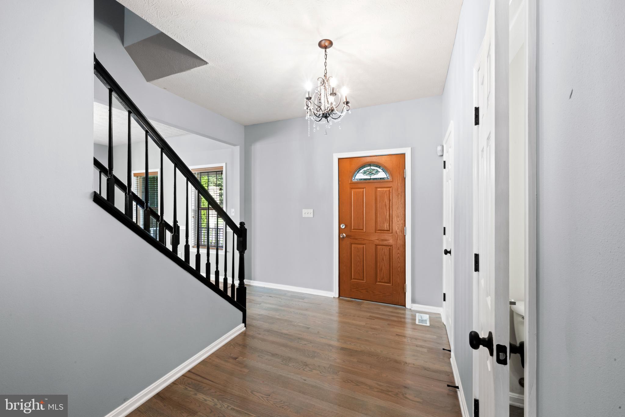 35184 Pheasant Ridge Road Locust Grove, VA 22508 - Photo 46 of 64 a view of a hallway with wooden floor and staircase