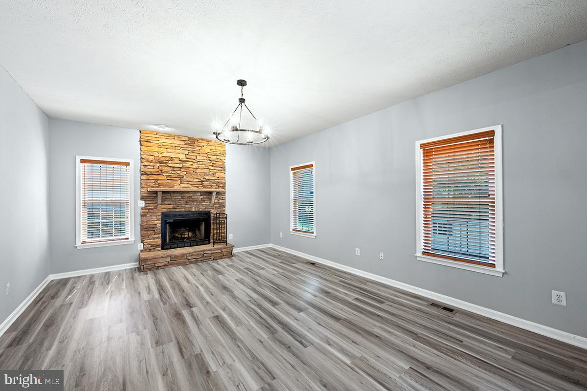 35184 Pheasant Ridge Road Locust Grove, VA 22508 - Photo 47 of 64 a view of an empty room with wooden floor fireplace and a window