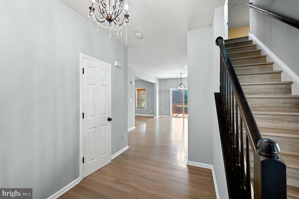 35184 Pheasant Ridge Road Locust Grove, VA 22508 - Photo 50 of 64 a view of a hallway with wooden floor and staircase