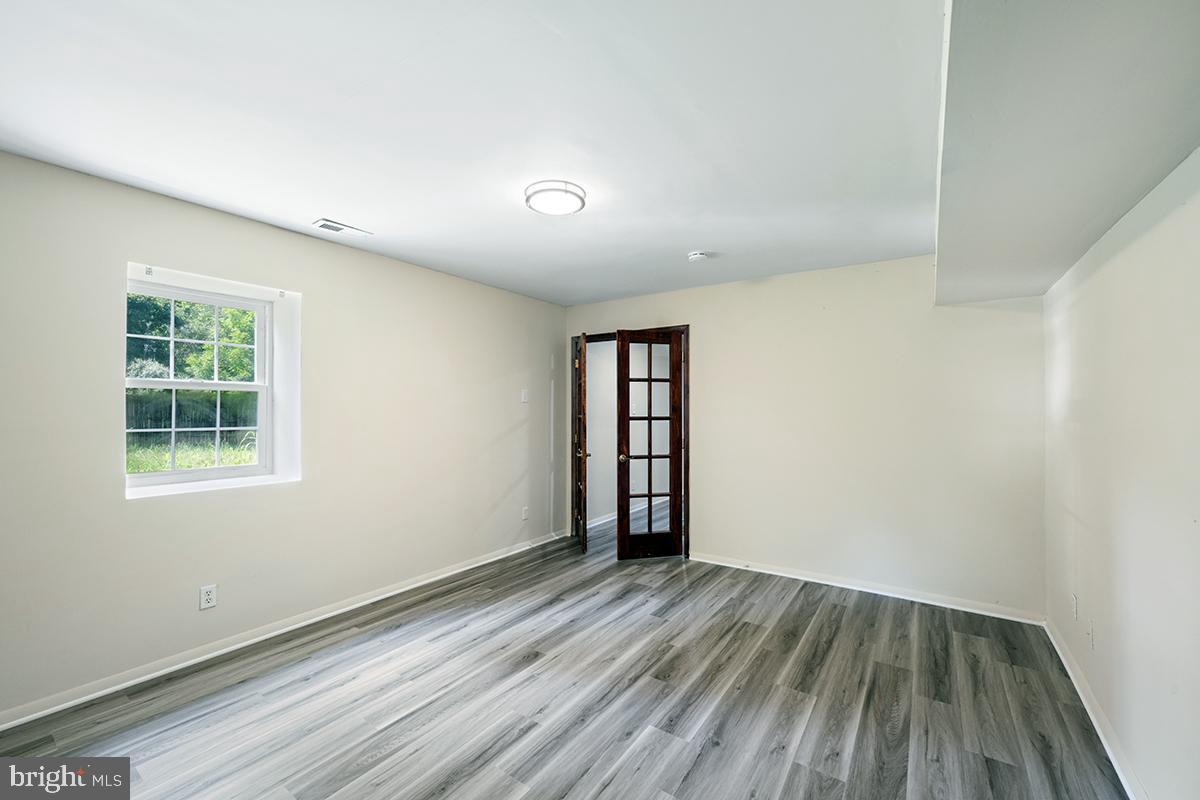 35184 Pheasant Ridge Road Locust Grove, VA 22508 - Photo 52 of 64 an empty room with wooden floor and windows