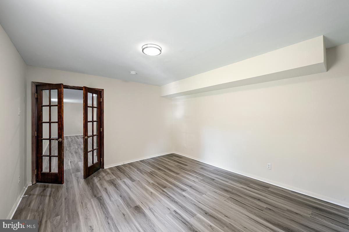 35184 Pheasant Ridge Road Locust Grove, VA 22508 - Photo 54 of 64 an empty room with wooden floor and natural light
