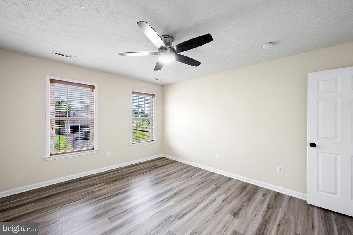 35184 Pheasant Ridge Road Locust Grove, VA 22508 - Photo 9 of 64 a view of an empty room with wooden floor and a window