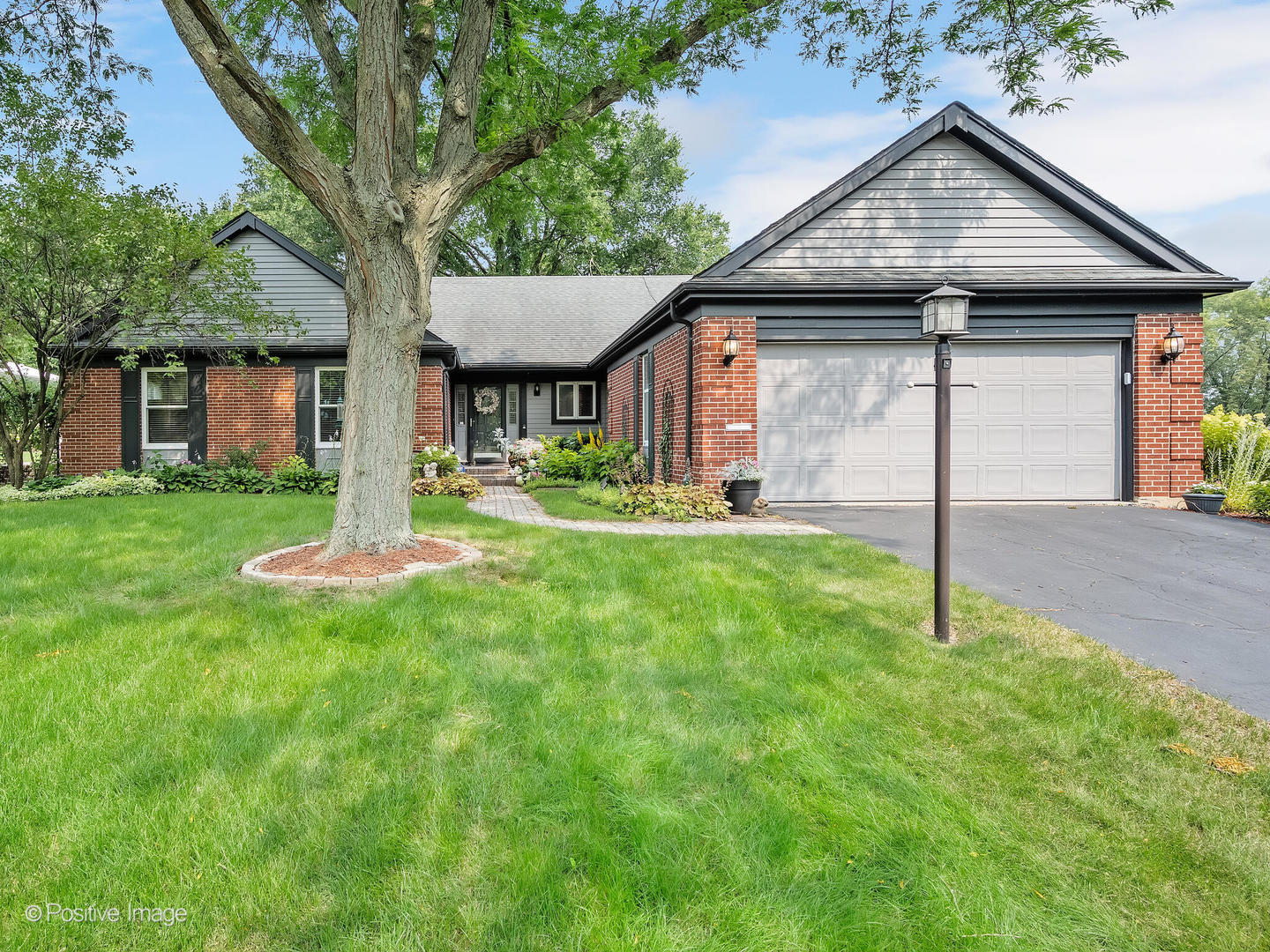 1303 Creekside Drive Wheaton, IL 60189 - Photo 1 of 3 a house that is sitting in the grass
