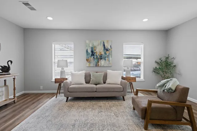 a living room with furniture and a potted plant