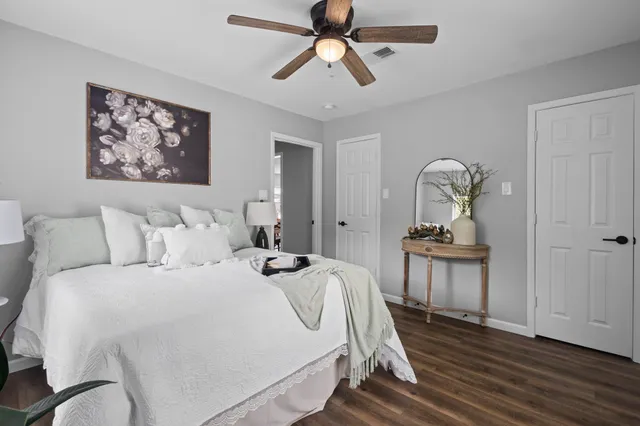 a bedroom with bed and wooden floor
