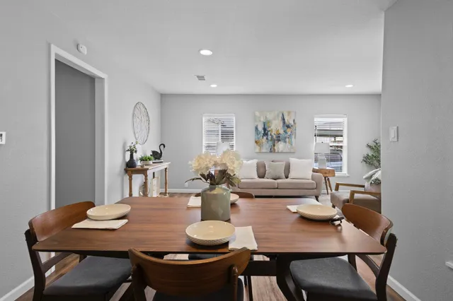 a view of a dining room with furniture and wooden floor