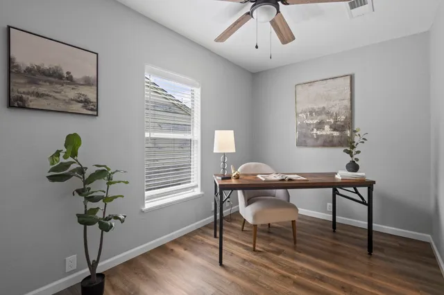 a view of a workspace with furniture and a potted plant