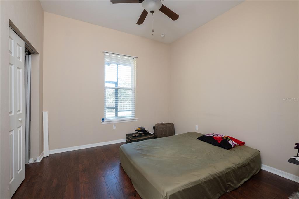 7775 Southwest 80th Drive Gainesville, FL 32608 - Photo 11 of 29 a bed sitting in a bedroom next to a window