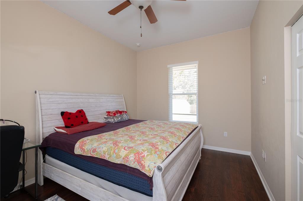 7775 Southwest 80th Drive Gainesville, FL 32608 - Photo 12 of 29 a bedroom with a bed and a dresser in it