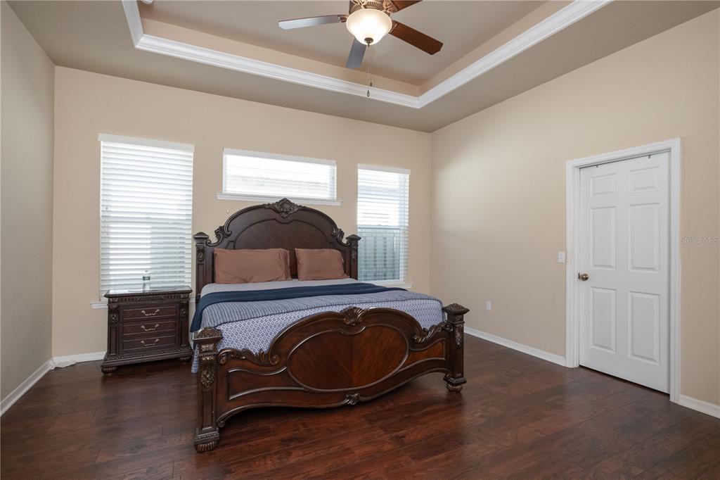 7775 Southwest 80th Drive Gainesville, FL 32608 - Photo 14 of 29 a bedroom with a bed and a chandelier