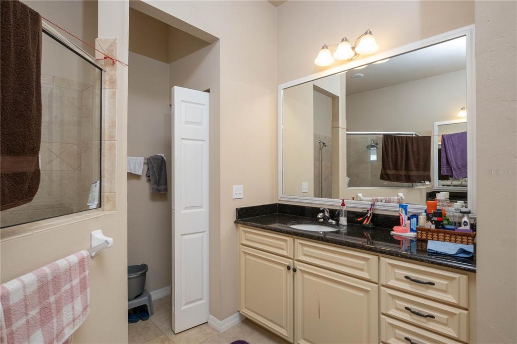 7775 Southwest 80th Drive Gainesville, FL 32608 - Photo 15 of 29 a bathroom with a sink and a mirror