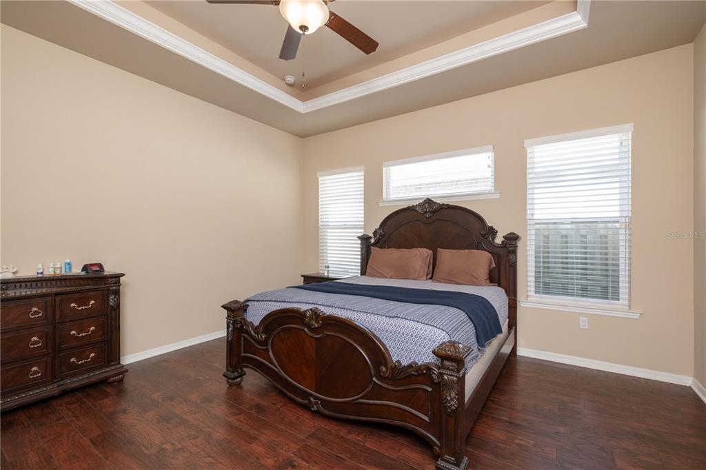 7775 Southwest 80th Drive Gainesville, FL 32608 - Photo 16 of 29 a bedroom with a bed and wooden floor