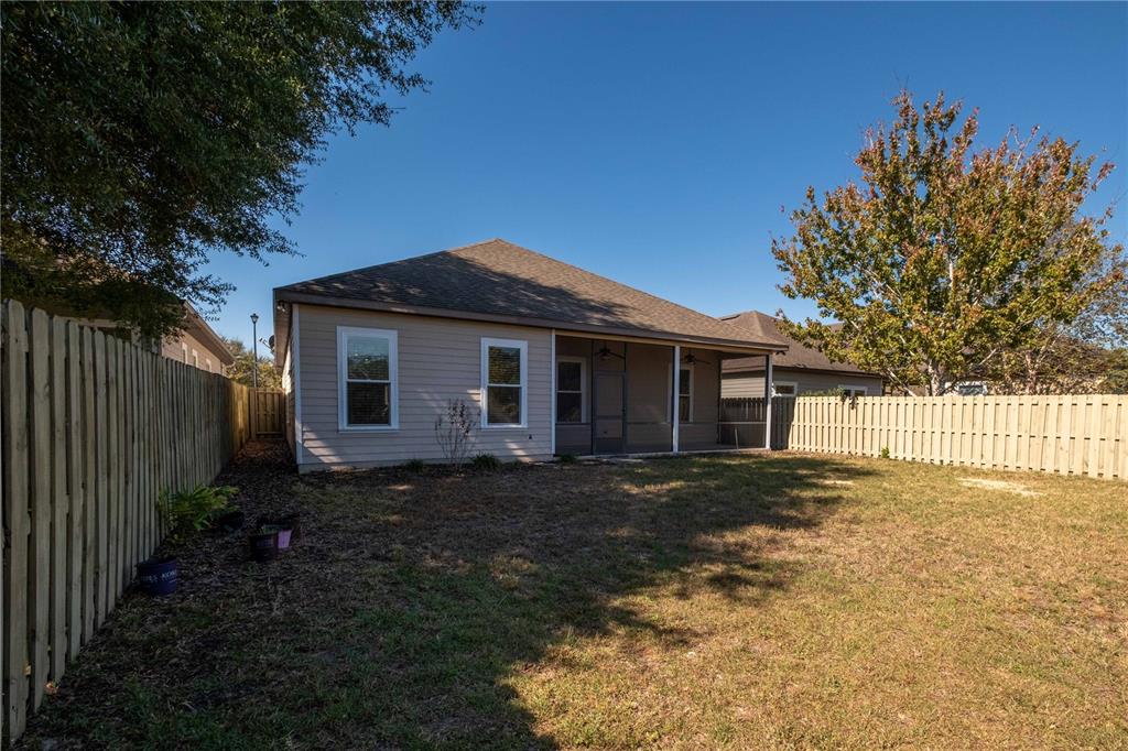 7775 Southwest 80th Drive Gainesville, FL 32608 - Photo 25 of 29 a front view of a house with a garden