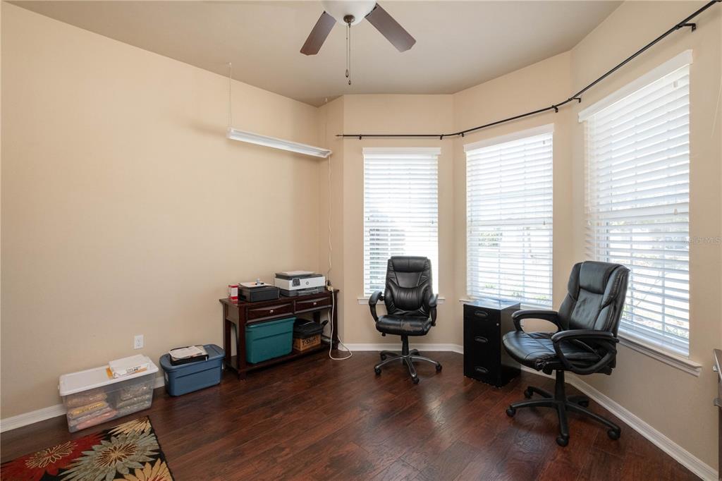 7775 Southwest 80th Drive Gainesville, FL 32608 - Photo 5 of 29 a view of a workspace with furniture and a window