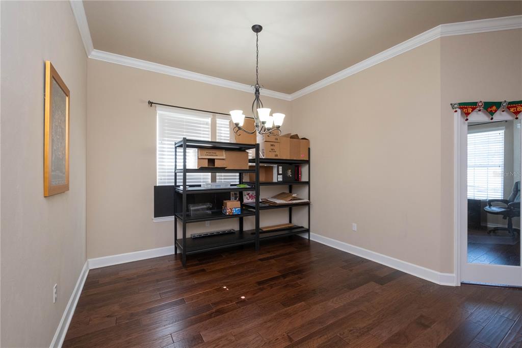 7775 Southwest 80th Drive Gainesville, FL 32608 - Photo 6 of 29 a view of a room with wooden floor and windows