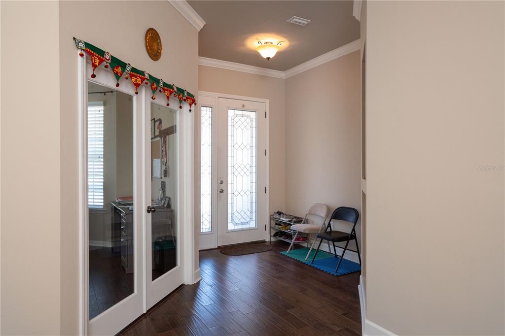 7775 Southwest 80th Drive Gainesville, FL 32608 - Photo 7 of 29 a view of entryway with livingroom and wooden floor