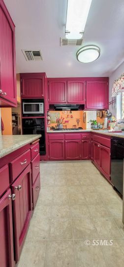 548 South Sanders Street Ridgecrest, CA 93555 - Photo 7 of 29 a large kitchen with stainless steel appliances granite countertop a stove sink and cabinets