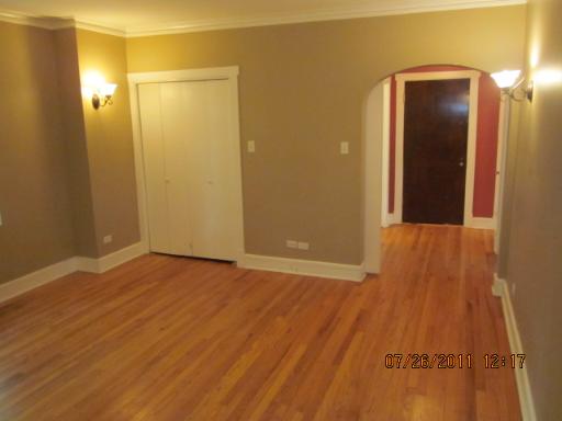 72 Pine Avenue, Unit 3B Riverside, IL 60546 - Photo 4 of 9 an empty room with wooden floor and a bathroom