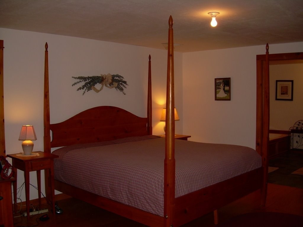 1005 Southbridge Road Warren, MA 01585 - Photo 13 of 30 a bedroom with a bed and a potted plant